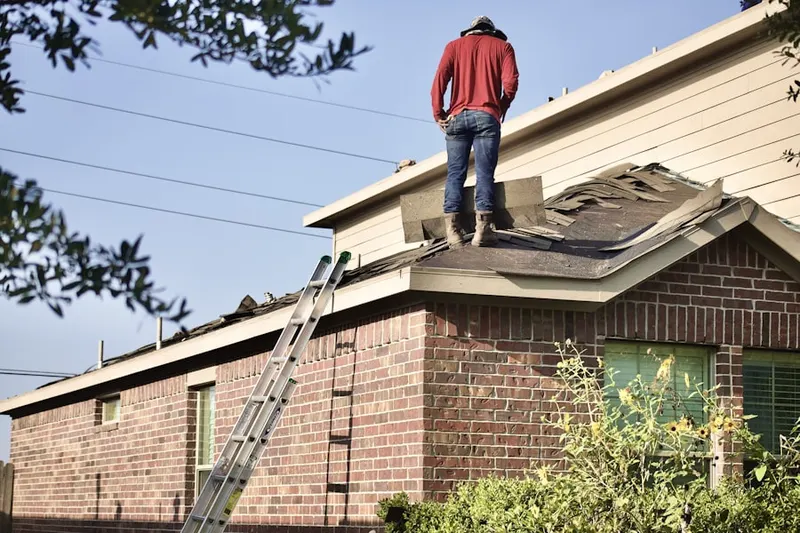 Professional roofer working on a residential roof in Embrey Hills